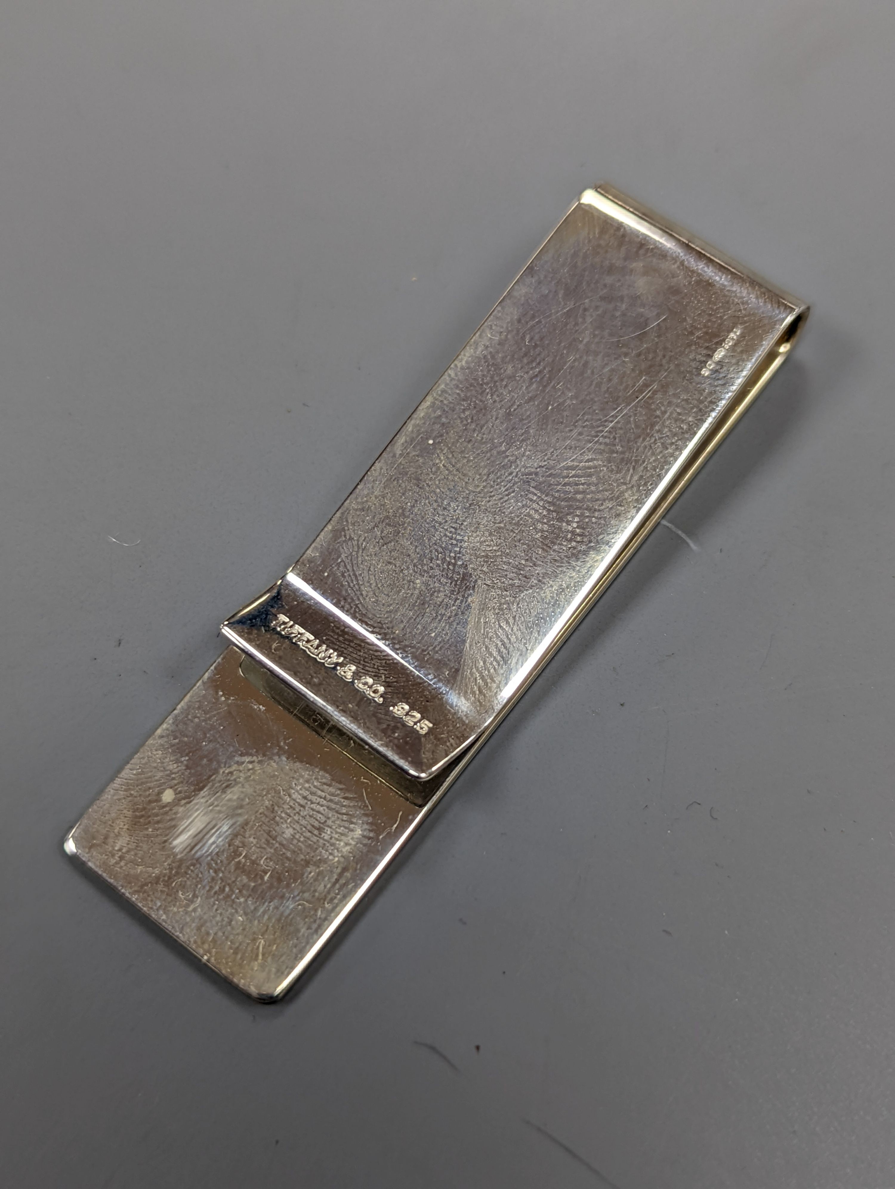 A boxed Tiffany & Co sterling silver money clip, and Parker and Sheffer fountain pens.